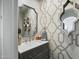 Stylish powder room with designer wallpaper, decorative mirrors, and a modern vanity at 6333 N Scottsdale Rd # 5, Scottsdale, AZ 85250