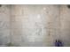 Modern shower with white marble tiling, chrome fixtures, and a sky light at 6333 N Scottsdale Rd # 5, Scottsdale, AZ 85250