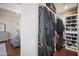 Organized walk-in closet with shelving, hanging racks, and ample storage space for clothes and accessories at 6333 N Scottsdale Rd # 5, Scottsdale, AZ 85250