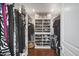Walk-in closet with custom shelving, clothing racks, and a storage basket at 6333 N Scottsdale Rd # 5, Scottsdale, AZ 85250