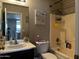 Bathroom featuring a sink, toilet and tub/shower combination with natural lighting and toiletries at 6538 W Nez Perce St, Phoenix, AZ 85043