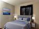 Serene bedroom featuring a bed with decorative pillows, a bedside table and stylish lamps and a soothing ambiance at 6538 W Nez Perce St, Phoenix, AZ 85043
