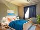 Inviting bedroom with a queen size bed, blue color palette and a serene and relaxing atmosphere at 6538 W Nez Perce St, Phoenix, AZ 85043