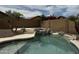 Backyard pool with a stacked stone waterfall feature and mature desert landscaping at 6538 W Nez Perce St, Phoenix, AZ 85043