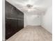 Open basement area showcasing built-in storage, tile flooring, and a ceiling fan at 845 N Oak Ct, Chandler, AZ 85226