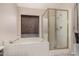 Bathroom with a separate shower and tub with tile surround and a window at 845 N Oak Ct, Chandler, AZ 85226