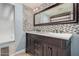 Bathroom with a modern vanity, double sinks, large mirror and mosaic tile backsplash at 845 N Oak Ct, Chandler, AZ 85226
