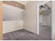 View of the bedroom space with neutral carpet, ceiling fan, and open door frame at 845 N Oak Ct, Chandler, AZ 85226