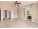 Bedroom with tile flooring, ceiling fan, and an open bathroom entrance at 845 N Oak Ct, Chandler, AZ 85226