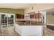 Well-equipped kitchen with a central island, granite countertops, and a view of the backyard at 845 N Oak Ct, Chandler, AZ 85226