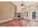 Bright living room featuring a stone fireplace, high ceilings, and a ceiling fan at 845 N Oak Ct, Chandler, AZ 85226