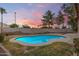 Sparkling pool with manicured landscaping and a block fence that provides privacy at 845 N Oak Ct, Chandler, AZ 85226