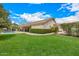 Spacious backyard featuring well-manicured lawn and covered patio with a pool in the distance at 8603 E Aster Dr, Scottsdale, AZ 85260