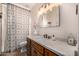 Bathroom featuring a modern vanity, decorative mirror, and patterned shower curtain at 8603 E Aster Dr, Scottsdale, AZ 85260