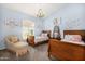 Charming bedroom with twin beds, floral accents, and a whimsical chandelier at 8603 E Aster Dr, Scottsdale, AZ 85260