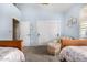 Bright bedroom featuring twin beds, light blue walls, and shuttered window at 8603 E Aster Dr, Scottsdale, AZ 85260