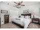 Comfortable bedroom features a neutral palette, plush bedding, and a decorative ceiling fan at 8603 E Aster Dr, Scottsdale, AZ 85260