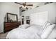 Bedroom with dark wood furniture, neutral walls, and decoratively shelved space above closet at 8603 E Aster Dr, Scottsdale, AZ 85260