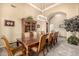 Spacious dining room with a long table, comfortable seating, and a decorative chandelier at 8603 E Aster Dr, Scottsdale, AZ 85260