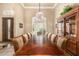 Formal dining room featuring a large table, elegant chandelier, and built-in display cabinet at 8603 E Aster Dr, Scottsdale, AZ 85260