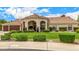 Beautiful single-story home with well-maintained lawn and arched entryway, showcasing classic design at 8603 E Aster Dr, Scottsdale, AZ 85260