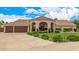 Charming home featuring a three-car garage and lush landscaping, enhancing its curb appeal at 8603 E Aster Dr, Scottsdale, AZ 85260