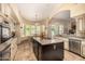 Gourmet kitchen equipped with a central island, stainless steel appliances, and a breakfast nook at 8603 E Aster Dr, Scottsdale, AZ 85260