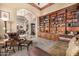 Elegant living room with custom built-in shelves, comfortable seating, and view to the dining room at 8603 E Aster Dr, Scottsdale, AZ 85260