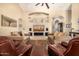 Inviting living room with a comfortable seating arrangement, fireplace, and wall-mounted TV at 8603 E Aster Dr, Scottsdale, AZ 85260