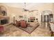 Spacious living room featuring high ceilings, a fireplace, and comfortable seating, ideal for Gathering gatherings at 8603 E Aster Dr, Scottsdale, AZ 85260
