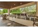 Gourmet outdoor kitchen with built-in stainless steel grill, sink, and ample counter space at 8603 E Aster Dr, Scottsdale, AZ 85260