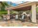 Covered outdoor kitchen and dining area with a built-in fireplace and seating at 8603 E Aster Dr, Scottsdale, AZ 85260
