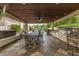 Spacious covered patio featuring a fully equipped outdoor kitchen, dining area and in ground pool at 8603 E Aster Dr, Scottsdale, AZ 85260