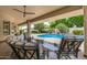 Covered patio overlooking pool and garden, perfect for outdoor entertaining at 8603 E Aster Dr, Scottsdale, AZ 85260