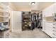 Spacious walk-in closet featuring custom shelves for organization and ample storage at 8603 E Aster Dr, Scottsdale, AZ 85260