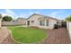 Landscaped backyard featuring a grassy area surrounded by gravel and the home's exterior at 8832 W Manzanita Dr, Peoria, AZ 85345