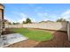 Landscaped backyard featuring a grassy area surrounded by gravel and a concrete patio at 8832 W Manzanita Dr, Peoria, AZ 85345