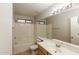 A bathroom with a shower-tub combo, a single sink vanity, tile flooring, and neutral walls at 8832 W Manzanita Dr, Peoria, AZ 85345