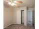 This carpeted bedroom features a ceiling fan and closet with sliding doors at 8832 W Manzanita Dr, Peoria, AZ 85345