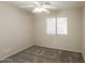 This carpeted bedroom features a ceiling fan and window with blinds at 8832 W Manzanita Dr, Peoria, AZ 85345
