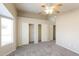 Bright and airy bedroom featuring neutral walls, carpeted floors, and a spacious closet with sliding doors at 8832 W Manzanita Dr, Peoria, AZ 85345