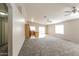Spacious living room featuring neutral walls, ceiling fans, carpeted floors, and natural light at 8832 W Manzanita Dr, Peoria, AZ 85345