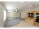 Large living room with carpet and tiled floors, open to kitchen with breakfast bar at 8832 W Manzanita Dr, Peoria, AZ 85345