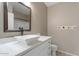 Bright bathroom featuring a modern vessel sink on a white vanity with a framed mirror and towel hooks at 9600 N 96Th St # 263, Scottsdale, AZ 85258