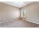 Neutral bedroom featuring a large window with plantation shutters and neutral carpet at 9600 N 96Th St # 263, Scottsdale, AZ 85258