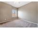 Neutral bedroom featuring a large window with plantation shutters and neutral carpet at 9600 N 96Th St # 263, Scottsdale, AZ 85258
