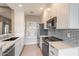 Well-lit kitchen boasts quartz countertops, a stainless steel sink, and modern appliances, perfect for culinary enthusiasts at 9600 N 96Th St # 263, Scottsdale, AZ 85258