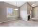 Living room with neutral walls and carpet, plantation shutters, a fireplace and modern light fixture at 9600 N 96Th St # 263, Scottsdale, AZ 85258