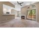 Spacious living room with an open layout, featuring a fireplace, kitchen bar, and access to a patio at 9600 N 96Th St # 263, Scottsdale, AZ 85258