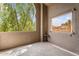 Enclosed patio featuring an arched window with natural lighting, a small table and textured walls at 9600 N 96Th St # 263, Scottsdale, AZ 85258